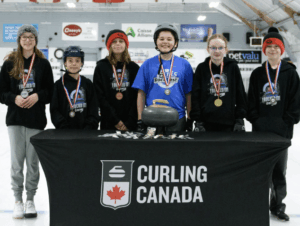 Youth Curlers standing with their medals