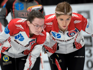 Young curlers deciding on a shot