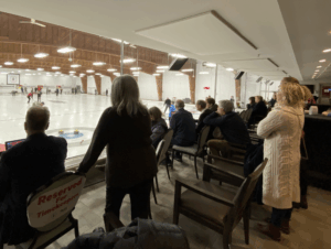 Spectators watching curling in a curling club