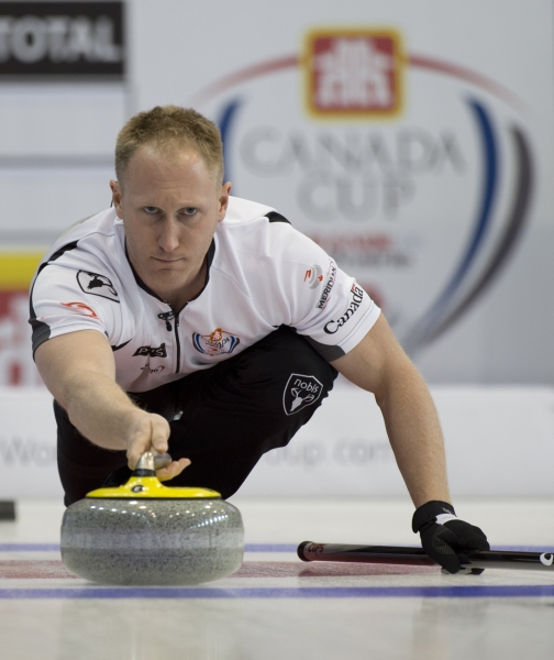 male curler in a competition releasing a rock