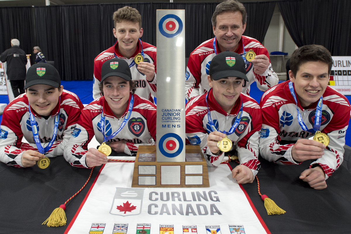 youth junior curlers holding their gold medals after their win