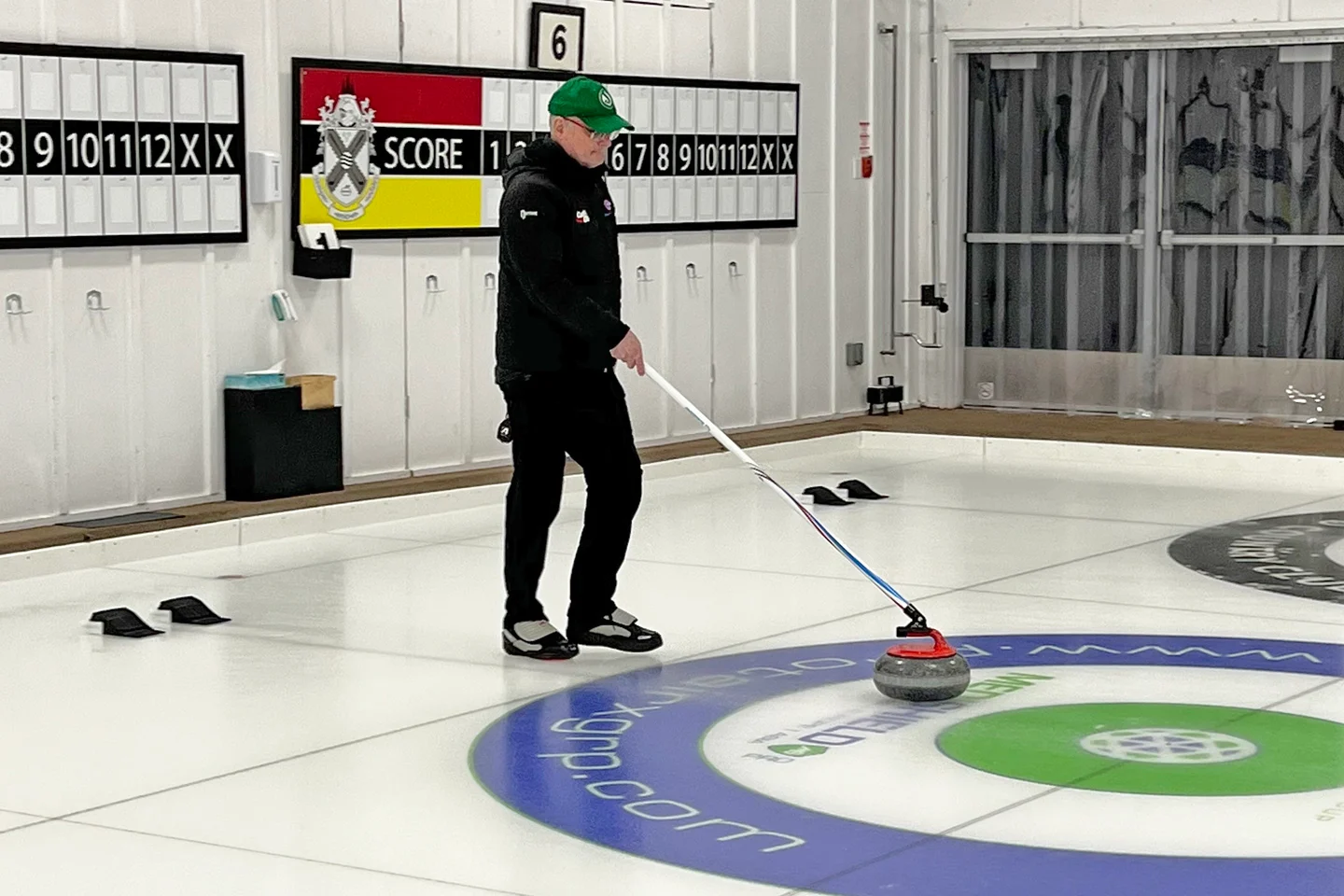 Curler using a stick to play stick curling