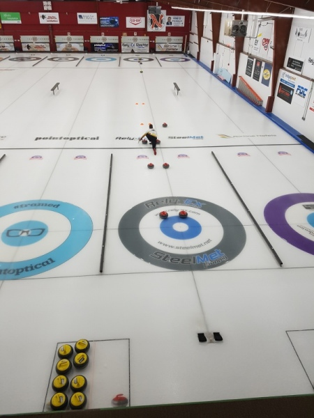 birds eye view for curling sliding down the ice doing the drill