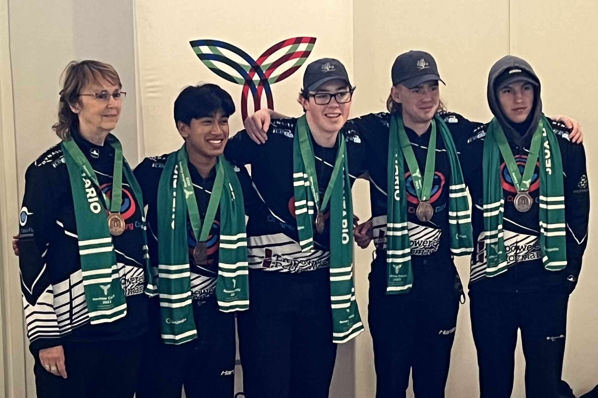 Academy team posing with medals and their coach at Ontario Games