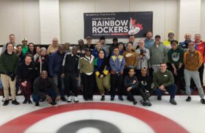 Rainbow Rockers league posing on the ice as a large group